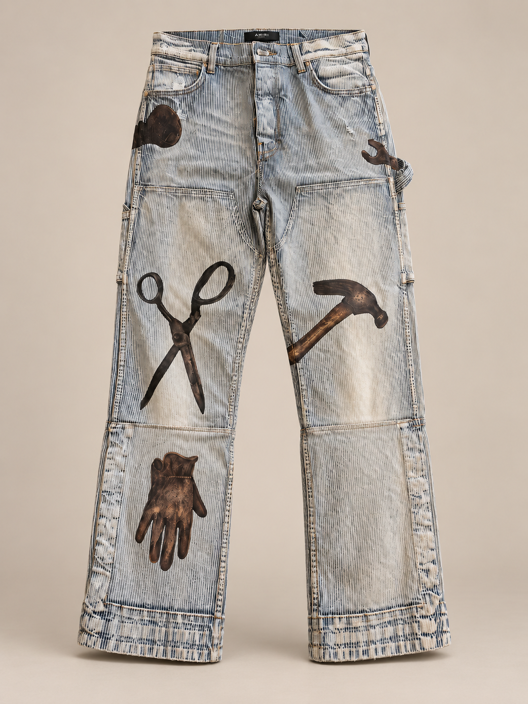 Full front view of the pale striped baggy patchwork jeans on a neutral taupe studio background